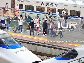 Passengers travel at Nanjing Railway Station in Nanjing, China, on September 30, 2024. (