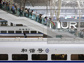 Passengers travel at Nanjing Railway Station in Nanjing, China, on September 30, 2024. (