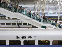 Passengers travel at Nanjing Railway Station in Nanjing, China, on September 30, 2024. (