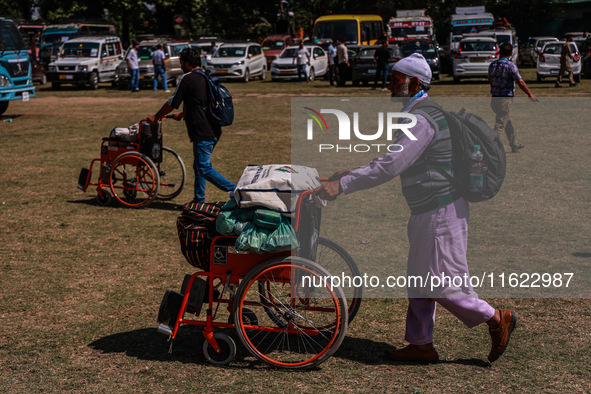 Kashmiri polling officials carry sealed Electronic Voting Machines (EVM) and Voter Verifiable Paper Audit Trail (VVPAT) machines as they mov...