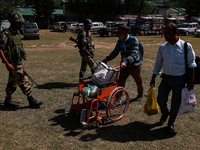 Kashmiri polling officials carry sealed Electronic Voting Machines (EVM) and Voter Verifiable Paper Audit Trail (VVPAT) machines as they mov...