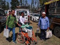 Kashmiri polling officials carry sealed Electronic Voting Machines (EVM) and Voter Verifiable Paper Audit Trail (VVPAT) machines as they mov...