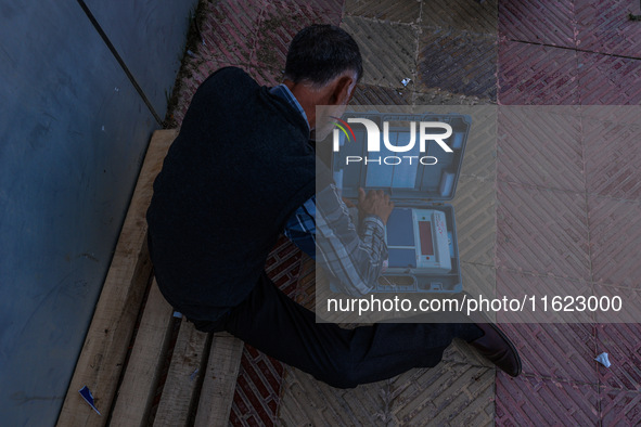 Kashmiri polling officials carry sealed Electronic Voting Machines (EVM) and Voter Verifiable Paper Audit Trail (VVPAT) machines as they mov...