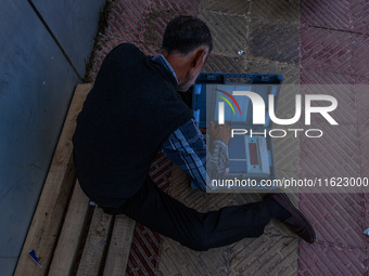 Kashmiri polling officials carry sealed Electronic Voting Machines (EVM) and Voter Verifiable Paper Audit Trail (VVPAT) machines as they mov...