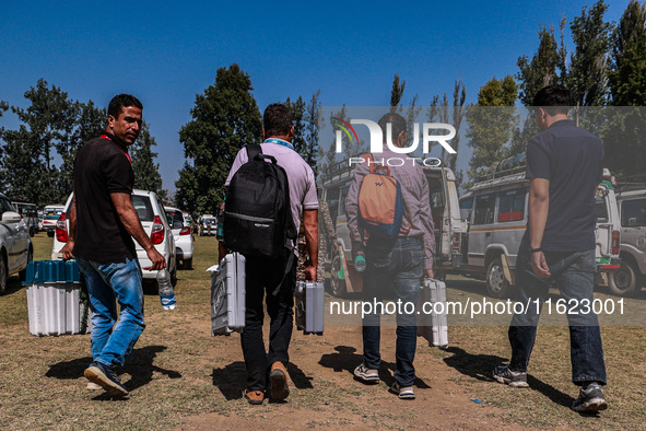 Kashmiri polling officials carry sealed Electronic Voting Machines (EVM) and Voter Verifiable Paper Audit Trail (VVPAT) machines as they mov...