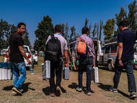 Kashmiri polling officials carry sealed Electronic Voting Machines (EVM) and Voter Verifiable Paper Audit Trail (VVPAT) machines as they mov...