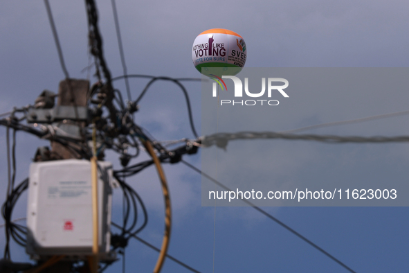 A gas-filled ball carries a message to cast a vote for the third phase of elections in Jammu and Kashmir, India, on October 1, 2024. 