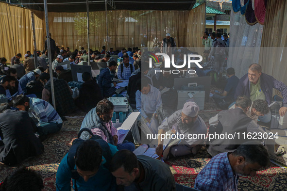 Polling officials with electronic voting machines (EVM) gather at a distribution center in Sumbal Area of Bandipora District, North of Srina...