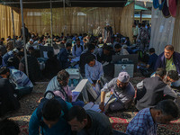 Polling officials with electronic voting machines (EVM) gather at a distribution center in Sumbal Area of Bandipora District, North of Srina...