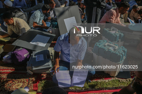 Polling officials with electronic voting machines (EVM) gather at a distribution center in Sumbal Area of Bandipora District, North of Srina...