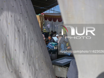 Polling officials with electronic voting machines (EVM) gather at a distribution center in Sumbal Area of Bandipora District, North of Srina...