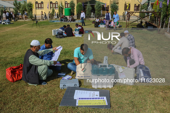 Polling officials with electronic voting machines (EVM) gather at a distribution center in Sumbal Area of Bandipora District, North of Srina...