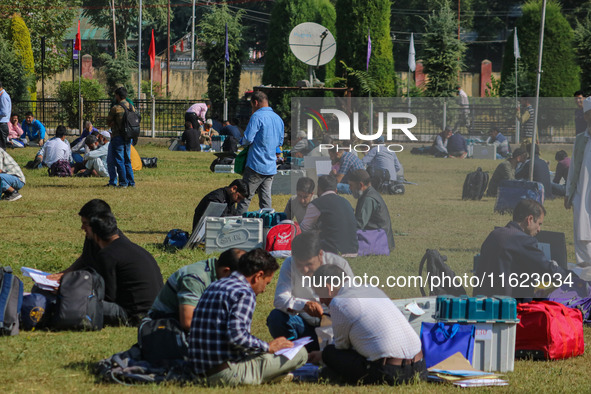 Polling officials with electronic voting machines (EVM) gather at a distribution center in Sumbal Area of Bandipora District, North of Srina...