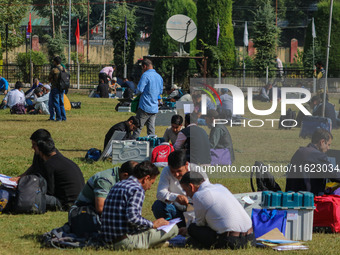 Polling officials with electronic voting machines (EVM) gather at a distribution center in Sumbal Area of Bandipora District, North of Srina...