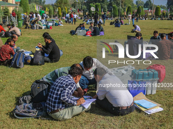 Polling officials with electronic voting machines (EVM) gather at a distribution center in Sumbal Area of Bandipora District, North of Srina...