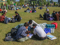 Polling officials with electronic voting machines (EVM) gather at a distribution center in Sumbal Area of Bandipora District, North of Srina...