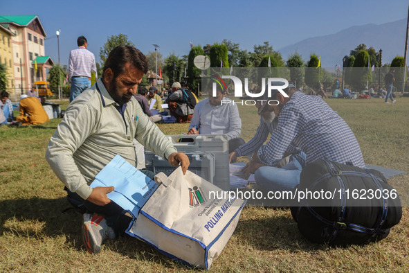 Polling officials with electronic voting machines (EVM) gather at a distribution center in Sumbal Area of Bandipora District, North of Srina...