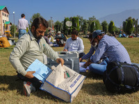 Polling officials with electronic voting machines (EVM) gather at a distribution center in Sumbal Area of Bandipora District, North of Srina...