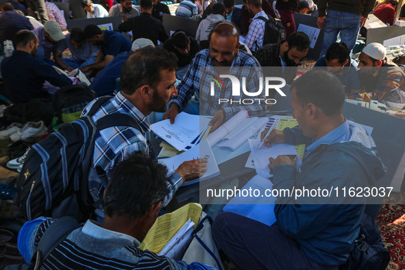 Polling officials with electronic voting machines (EVM) gather at a distribution center in Sumbal Area of Bandipora District, North of Srina...