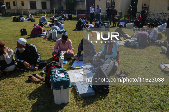 Polling officials with electronic voting machines (EVM) gather at a distribution center in Sumbal Area of Bandipora District, North of Srina...