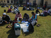 Polling officials with electronic voting machines (EVM) gather at a distribution center in Sumbal Area of Bandipora District, North of Srina...