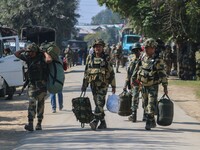 An Indian paramilitary soldier walks outside a distribution center in the Sumbal area of Bandipora district, north of Srinagar, on September...