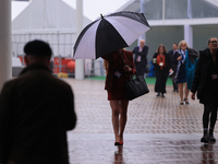 Delegates arrive in the pouring rain to the Conservative Party Conference at the International Conference Centre in Birmingham, United Kingd...