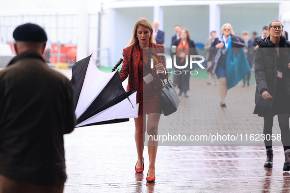 Delegates arrive in the pouring rain to the Conservative Party Conference at the International Conference Centre in Birmingham, United Kingd...