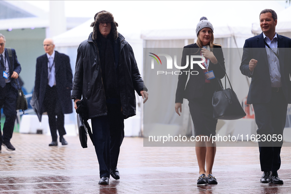 Delegates arrive in the pouring rain to the Conservative Party Conference at the International Conference Centre in Birmingham, United Kingd...