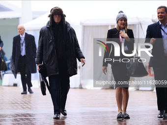 Delegates arrive in the pouring rain to the Conservative Party Conference at the International Conference Centre in Birmingham, United Kingd...