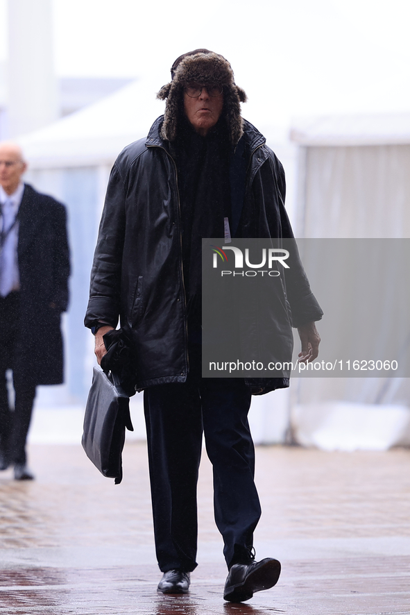 Delegates arrive in the pouring rain to the Conservative Party Conference at the International Conference Centre in Birmingham, United Kingd...