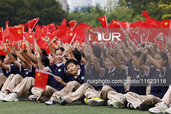 More than 7,000 teachers and students of Hongxiang Education Group sing and dance to celebrate National Day in Sihong County, Suqian, China,...