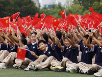 More than 7,000 teachers and students of Hongxiang Education Group sing and dance to celebrate National Day in Sihong County, Suqian, China,...