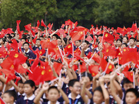 More than 7,000 teachers and students of Hongxiang Education Group sing and dance to celebrate National Day in Sihong County, Suqian, China,...