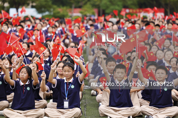 More than 7,000 teachers and students of Hongxiang Education Group sing and dance to celebrate National Day in Sihong County, Suqian, China,...