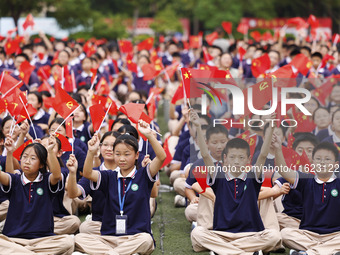 More than 7,000 teachers and students of Hongxiang Education Group sing and dance to celebrate National Day in Sihong County, Suqian, China,...