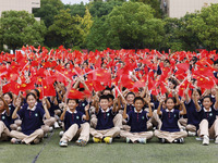 More than 7,000 teachers and students of Hongxiang Education Group sing and dance to celebrate National Day in Sihong County, Suqian, China,...