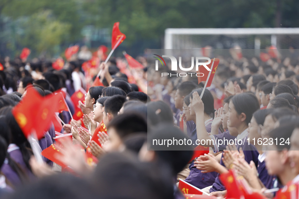 More than 7,000 teachers and students of Hongxiang Education Group sing and dance to celebrate National Day in Sihong County, Suqian, China,...