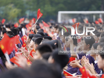 More than 7,000 teachers and students of Hongxiang Education Group sing and dance to celebrate National Day in Sihong County, Suqian, China,...