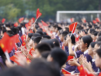 More than 7,000 teachers and students of Hongxiang Education Group sing and dance to celebrate National Day in Sihong County, Suqian, China,...