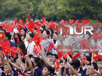 More than 7,000 teachers and students of Hongxiang Education Group sing and dance to celebrate National Day in Sihong County, Suqian, China,...