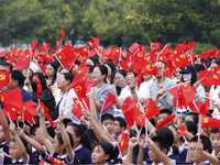 More than 7,000 teachers and students of Hongxiang Education Group sing and dance to celebrate National Day in Sihong County, Suqian, China,...