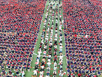 More than 7,000 teachers and students of Hongxiang Education Group sing and dance to celebrate National Day in Sihong County, Suqian, China,...