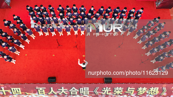 More than 7,000 teachers and students of Hongxiang Education Group sing and dance to celebrate National Day in Sihong County, Suqian, China,...