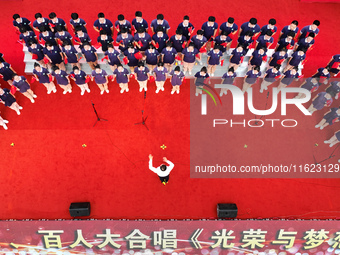 More than 7,000 teachers and students of Hongxiang Education Group sing and dance to celebrate National Day in Sihong County, Suqian, China,...