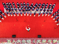 More than 7,000 teachers and students of Hongxiang Education Group sing and dance to celebrate National Day in Sihong County, Suqian, China,...