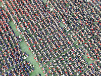 More than 7,000 teachers and students of Hongxiang Education Group sing and dance to celebrate National Day in Sihong County, Suqian, China,...