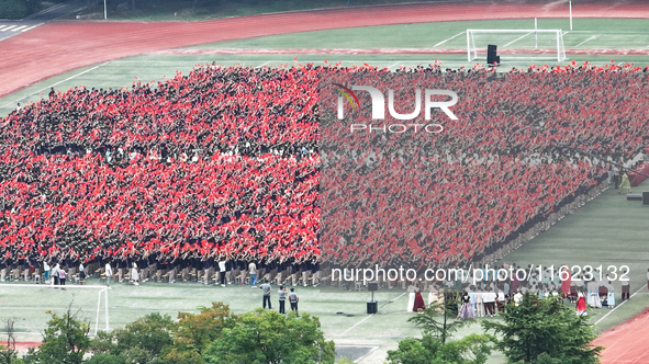 More than 7,000 teachers and students of Hongxiang Education Group sing and dance to celebrate National Day in Sihong County, Suqian, China,...