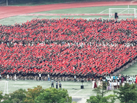 More than 7,000 teachers and students of Hongxiang Education Group sing and dance to celebrate National Day in Sihong County, Suqian, China,...