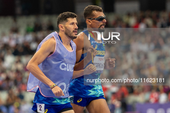 Julio Cesar Agripino dos Santos of Team Brazil celebrates with guide Romario Santos Viana a new World Record of 14:48:85 in the Men's 5000m...